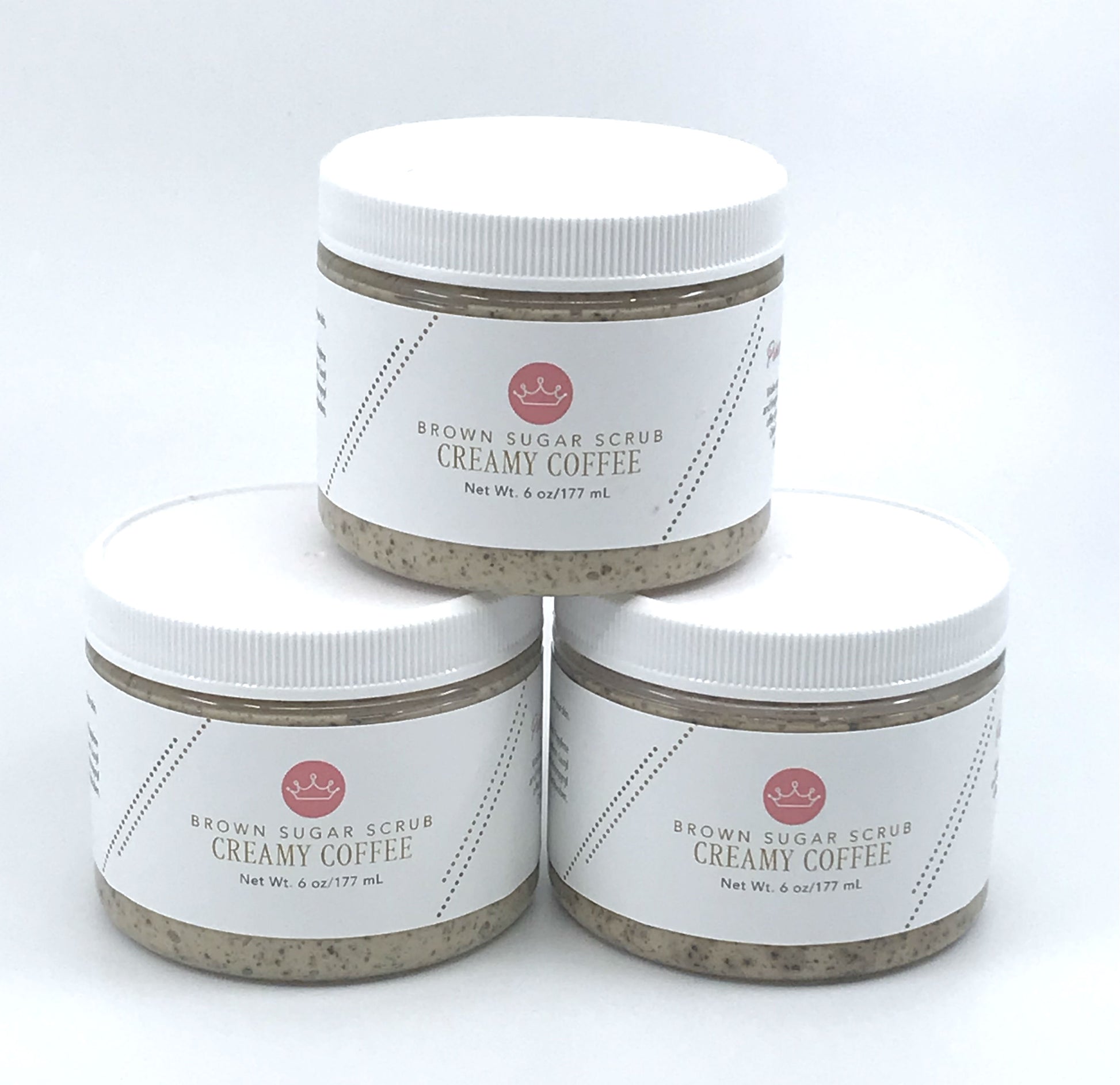 Three brown coffee sugar scrubs stacked in a triangle