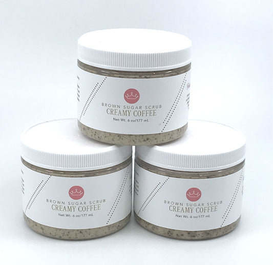 Three brown coffee sugar scrubs stacked in a triangle